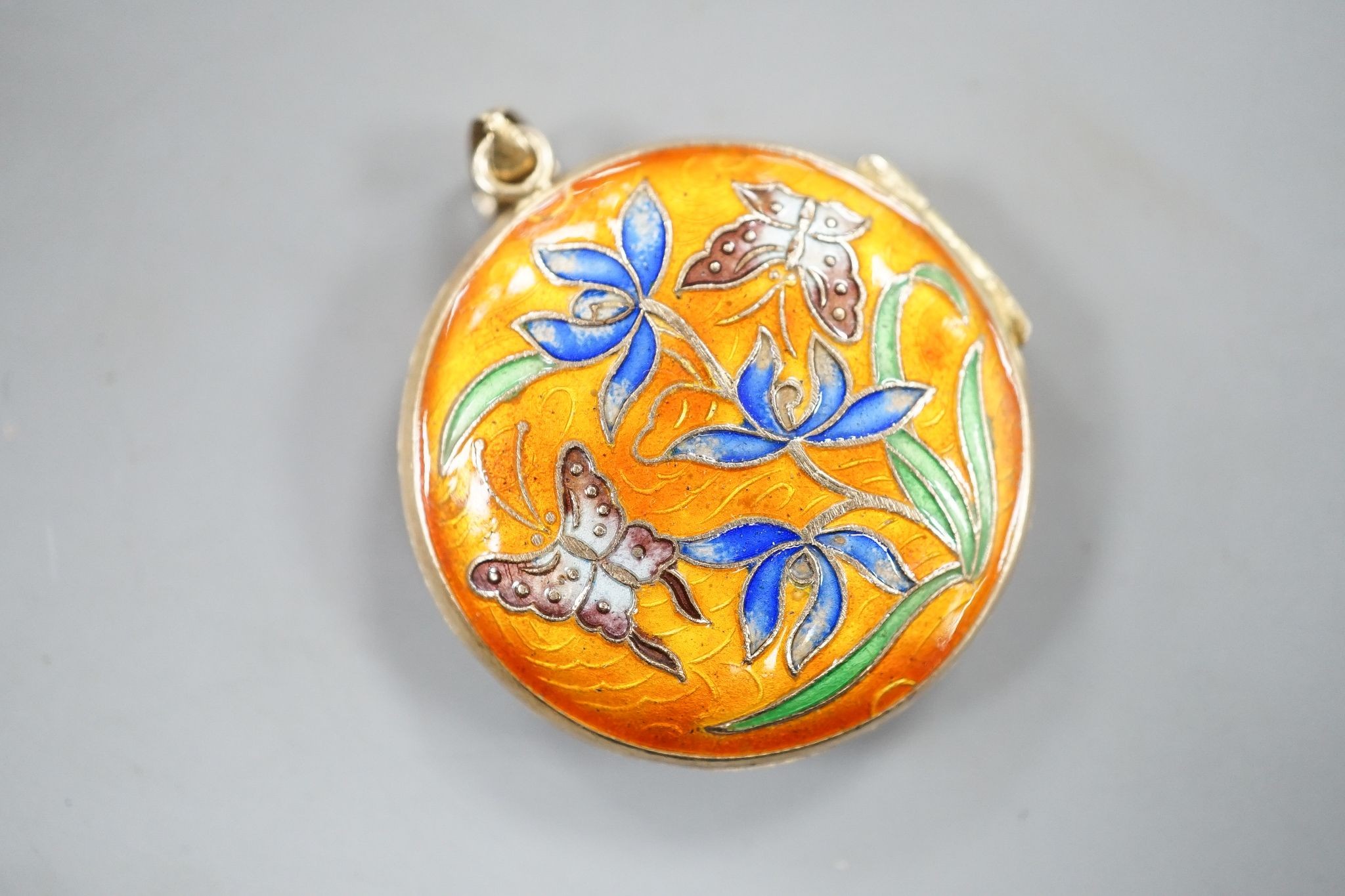 A 14k yellow metal and carved jade set pendant, 45mm, gross 8.5 grams, on a 9ct gold ropetwist chain, 56cm, 10.5 grams and an enamelled gilt white metal pendant.